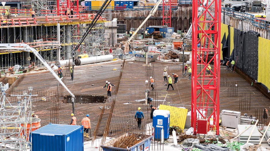 A bustling construction site in Hamburg with workers and equipment actively engaged in building tasks.